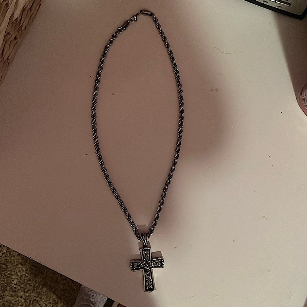 Silver cross chain with black details.